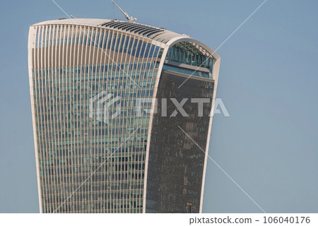Closeup of iconic futuristic building of Walkie Talkie. Skyscraper with clear blue sky in background. 20 Fenchurch Street on sunny day. Closeup of iconic futuristic building of Walkie Talkie. Skyscraper with clear blue sky in background. 20 Fenchurch Street on sunny day. 106040176