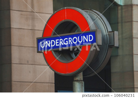 Red logo with Underground text. Its Symbol of London Transport. Sign board at public subway. 106040231