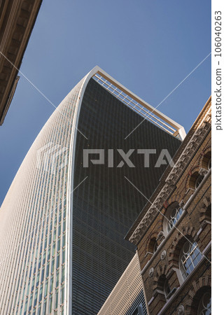 Iconic 20 Fenchurch Street with blue sky in background. Walkie Talkie building in city on sunny day. Famous skyscraper in London. Iconic 20 Fenchurch Street with blue sky in background. Walkie Talkie building in city on sunny day. Famous skyscraper in London. 106040263