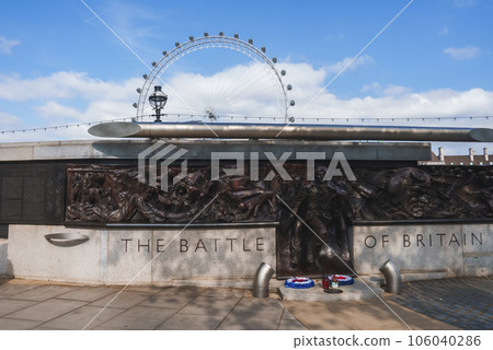The Battle of Britain memorial at Victoria Embankment on sunny day. View of Millennial wheel with sky in background. Famous monument is in Westminster city of London. 106040286