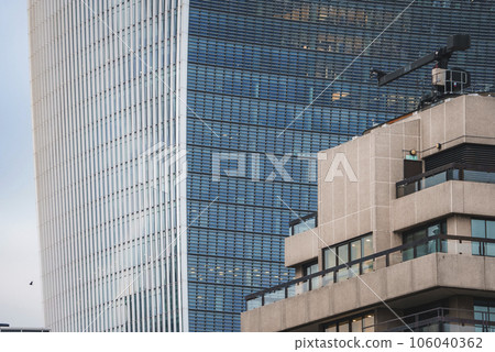 View of famous 20 Fenchurch Street in city. Financial office building with glass windows. Beautiful modern structure in city of London. 106040362