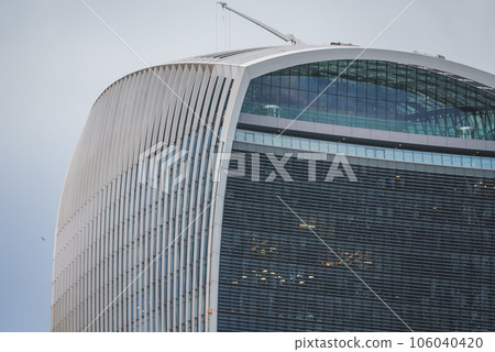 Top view of famous 20 Fenchurch Street in city. Financial skyscraper with glass windows. Beautiful modern structure with unique design in city of London. 106040420