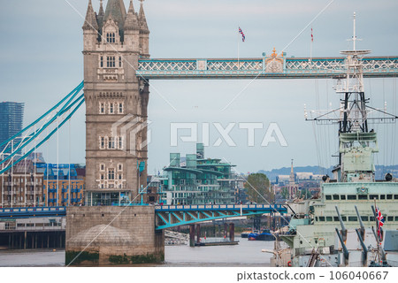 Iconic Tower Bridge connecting Londong with Southwark on the Thames River. Close up view of the HMS Belfast Iconic Tower Bridge connecting Londong with Southwark on the Thames River. Close up view of the HMS Belfast 106040667