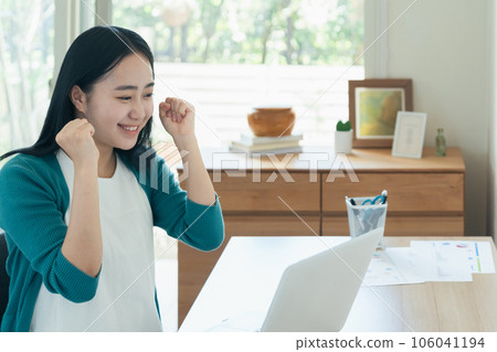 Young woman happy in front of a computer Young woman happy in front of a computer 106041194