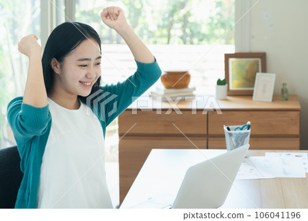 Young woman happy in front of a computer Young woman happy in front of a computer 106041196