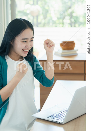 Young woman happy in front of a computer Young woman happy in front of a computer 106041205