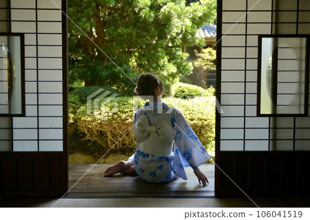 Back view of a woman wearing a yukata sitting on the porch Back view of a woman wearing a yukata sitting on the porch 106041519