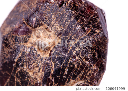 Macro of a mineral garnet stone on a white background 106041999