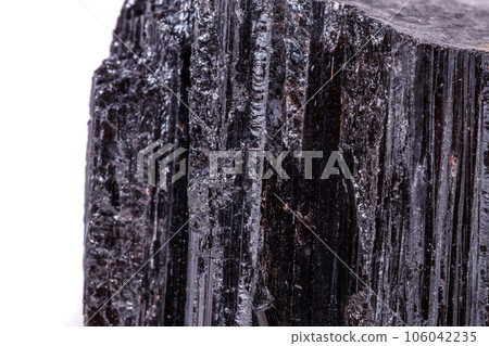 macro mineral stone sherle, schorl, black tourmaline on white background macro mineral stone sherle, schorl, black tourmaline on white background 106042235