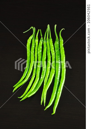 chili pepper on a black background. 106042981