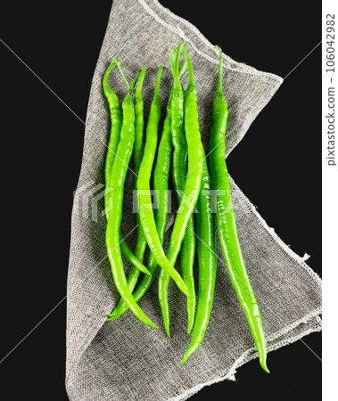 chili pepper on a black background. chili pepper on a black background. 106042982