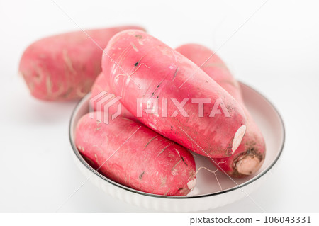 red-skinned radish placed on a white background. 106043331