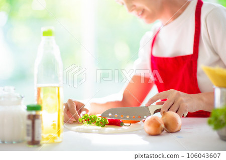 Woman cooking dinner. Cook spaghetti 106043607