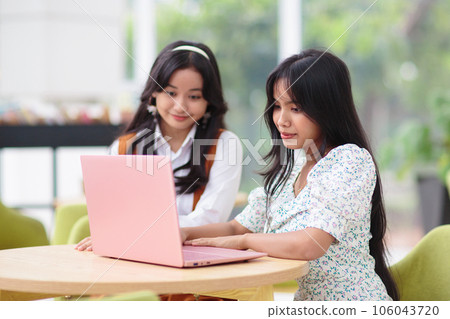 Beautiful young girls with laptop 106043720