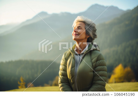 Serene Senior Woman Engaging in Morning Breathing Ritual Amidst Nature's Beauty Serene Senior Woman Engaging in Morning Breathing Ritual Amidst Nature's Beauty 106045190