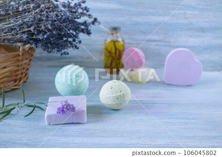 Lavender soap, fragrance oil, foam bombs and fresh lavender flowers on a wooden background, bath products Lavender soap, fragrance oil, foam bombs and fresh lavender flowers on a wooden background, bath products 106045802