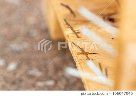 close up view of nails sticking out of a broken Crate close up view of nails sticking out of a broken Crate 106047040