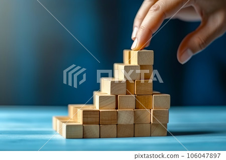 Person placing piece of wood on top of wooden block pyramid. Generative AI 106047897