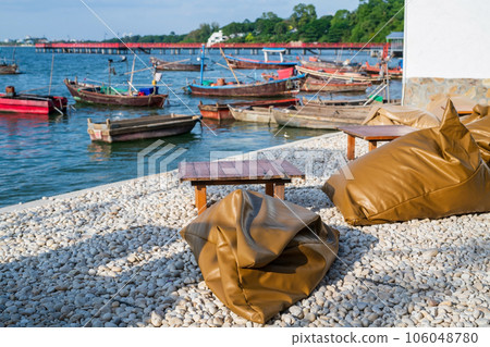 Soft beanbags and table on white rocks by sea, Siracha, Chonburi Soft beanbags and table on white rocks by sea, Siracha, Chonburi 106048780