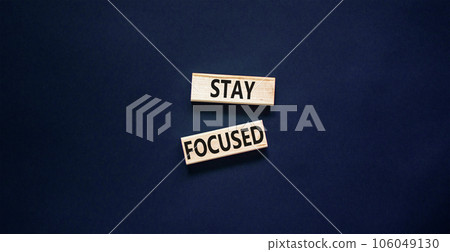 Stay focused symbol. Concept words Stay focused on wooden blocks on a beautiful black table black background. Business, support, motivation, psychological and stay focused concept. Copy space. 106049130