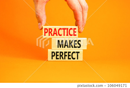 Practice makes perfect symbol. Concept words Practice makes perfect on wooden block. Beautiful orange table orange background. Businessman hand. Business practice makes perfect concept. Copy space. 106049171