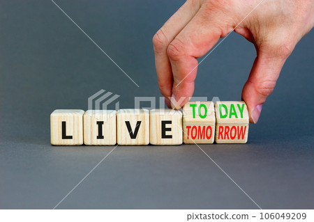 Live today not tomorrow symbol. Businessman turns wooden cubes and changes word Live tomorrow to Live today. Beautiful grey background. Business and live today not tomorrow concept. Copy space. 106049209