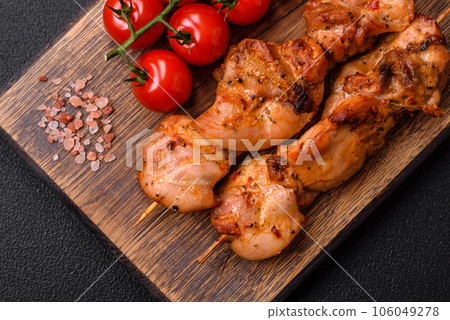 Delicious fresh, juicy chicken or pork kebab on skewers with salt and spices 106049278