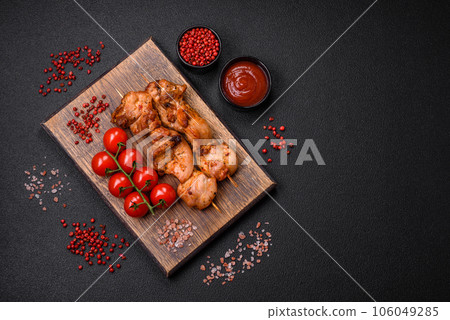 Delicious fresh, juicy chicken or pork kebab on skewers with salt and spices Delicious fresh, juicy chicken or pork kebab on skewers with salt and spices 106049285