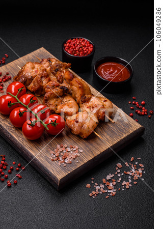 Delicious fresh, juicy chicken or pork kebab on skewers with salt and spices Delicious fresh, juicy chicken or pork kebab on skewers with salt and spices 106049286