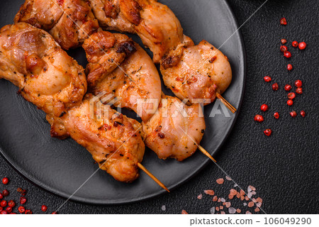 Delicious fresh, juicy chicken or pork kebab on skewers with salt and spices 106049290