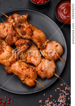 Delicious fresh, juicy chicken or pork kebab on skewers with salt and spices 106049291