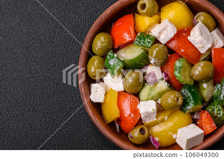 Delicious fresh, juicy Greek salad with feta cheese, olives, tomatoes, cucumber 106049300