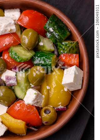 Delicious fresh, juicy Greek salad with feta cheese, olives, tomatoes, cucumber 106049311