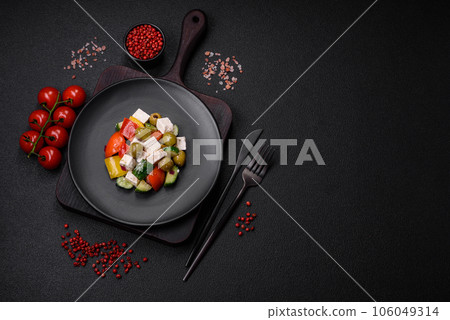 Delicious fresh, juicy Greek salad with feta cheese, olives, tomatoes, cucumber 106049314