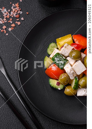 Delicious fresh, juicy Greek salad with feta cheese, olives, tomatoes, cucumber 106049321