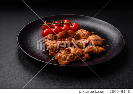 Delicious fresh, juicy chicken or pork kebab on skewers with salt and spices 106049348