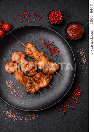 Delicious fresh, juicy chicken or pork kebab on skewers with salt and spices Delicious fresh, juicy chicken or pork kebab on skewers with salt and spices 106049407