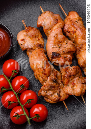 Delicious fresh, juicy chicken or pork kebab on skewers with salt and spices 106049408