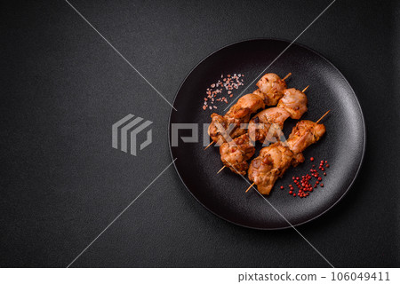 Delicious fresh, juicy chicken or pork kebab on skewers with salt and spices 106049411