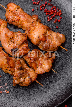 Delicious fresh, juicy chicken or pork kebab on skewers with salt and spices Delicious fresh, juicy chicken or pork kebab on skewers with salt and spices 106049412
