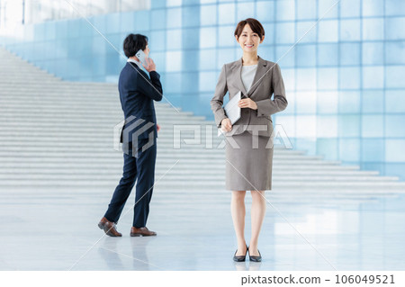 Business person standing in the lobby of a company Business person standing in the lobby of a company 106049521