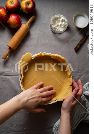 Cooking apple pie pastry. Raw dough in pie tin. 106049618