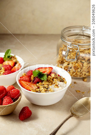 Oatmeal porridge with strawberry, homemade granola. Healthy breakfast. 106049626