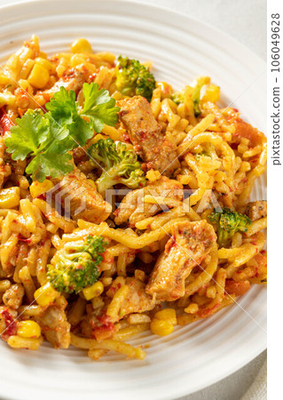 Stir-fried egg noodles with chicken breast in a white plate. Stir-fried egg noodles with chicken breast in a white plate. 106049628