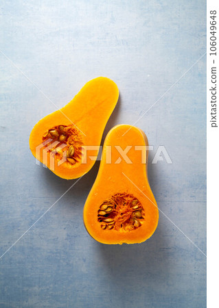 Butternut squash pumpkin and seeds on blue background Butternut squash pumpkin and seeds on blue background 106049648