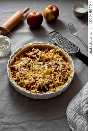 Cooking apple pie pastry. Raw pie with red apples in baking tin Cooking apple pie pastry. Raw pie with red apples in baking tin 106049649