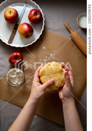 Homemade apple pie pastry. Cooking process, raw dough for pie. 106049656