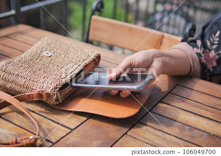 women taking smart phone our from her casual purse women taking smart phone our from her casual purse 106049700