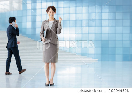 business person standing in lobby business person standing in lobby 106049808