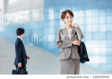 Business person standing in the lobby of a company Business person standing in the lobby of a company 106049809